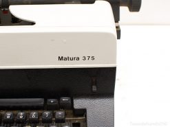 Classic Matura 375 typewriter in cream and black, showcasing vintage design and historical charm.