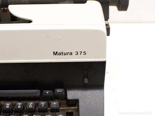 Classic Matura 375 typewriter in cream and black, showcasing vintage design and historical charm.
