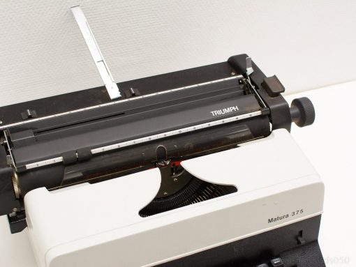 Vintage Triumph Matura 375 typewriter in classic white and black—perfect for collectors and writers.