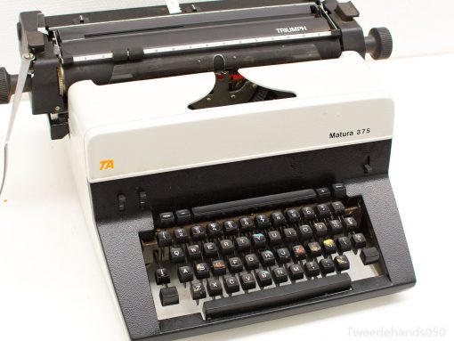 Vintage Triumph Matura 375 typewriter in classic white and black, perfect for nostalgic writers.