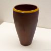Contemporary dark brown vase with striking yellow rim, perfect for stylish home decor.