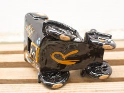 Whimsical black vintage car figurine with vibrant gold and blue accents, perfect for decor.