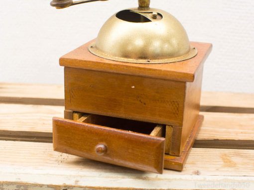 Charming vintage coffee grinder with wooden body and brass lid, perfect for coffee enthusiasts.