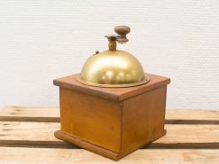 Elegant vintage brass bell with wooden base, perfect for decor and nostalgia.