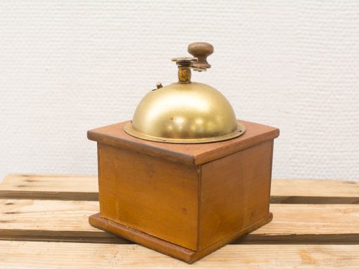 Elegant vintage brass bell with wooden base, perfect for decor and nostalgia.