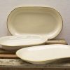 Elegant porcelain serving dishes with golden rims, perfect for festive meals and gatherings.