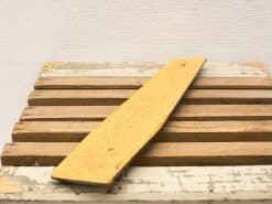 Warm golden cork piece on rustic wooden surface, perfect for creative decor and projects.