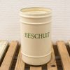 Vintage cream canister for storing hard biscuits, featuring elegant green lettering and rustic charm.