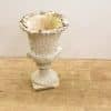 Antique urn with weathered patina and elegant curves, perfect for vintage garden decor.
