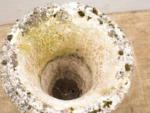Weathered stone planter with moss, showcasing rustic charm for garden decor.