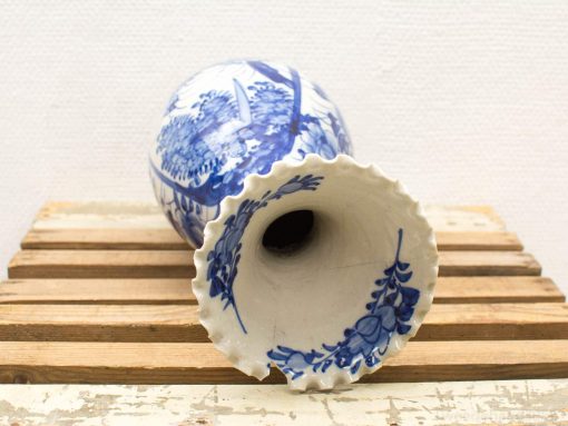 Elegant blue and white ceramic vase with scalloped edge, perfect for home decor or floral arrangements.