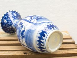 Elegant blue and white vintage porcelain vase with intricate floral designs.