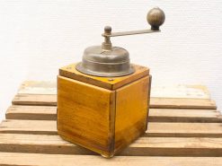 Classic wooden coffee grinder with vintage metal mechanism, perfect for coffee enthusiasts and decor.