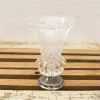 Elegant crystal vase with metallic base, showcasing intricate craftsmanship and timeless design.