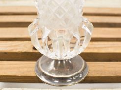 Elegant diamond-cut glass vase with vintage silver pedestal, perfect for refined decor.