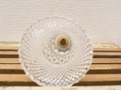 Elegant crystal decor piece with a contrasting center, beautifully displayed on a rustic wooden base.