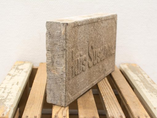 Vintage stone block with inscription, perfect for adding character to any decor.