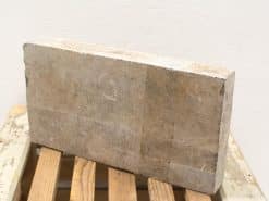 Rustic stone block on aged wood, perfect for vintage decor or functional interior design.
