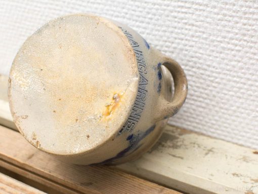 Vintage stoneware margarine container with handle, showcasing unique craftsmanship and historical charm.