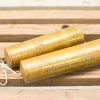 Vintage brass maracas with patina and rope, showcasing rustic charm and craftsmanship.