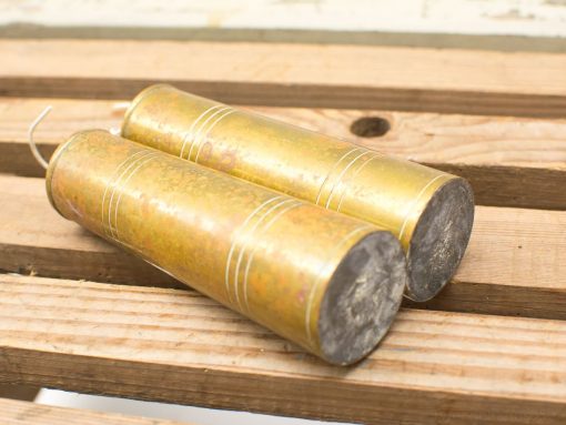 Vintage brass cylinders with patina, showcasing unique craftsmanship and historical charm for decor.