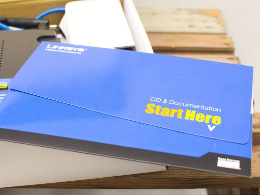 Linksys router setup kit with documentation, cables, and easy installation guide.