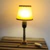 Charming vintage lamp with yellow shade and bronze base, perfect for creating a cozy atmosphere.