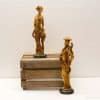 Intricate wooden sculptures of a man and woman highlighting cultural artistry and craftsmanship.