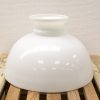 Glossy white ceramic bowl on rustic wood, combining modern elegance with functional charm.