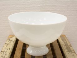 Minimalist white bowl on wood stand, perfect for serving and enhancing table decor.