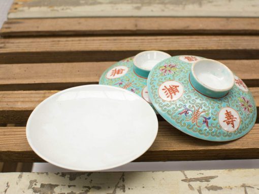 Charming vintage ceramic set featuring a white plate and ornate turquoise bowls.