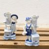 Charming ceramic figurine vases of a boy and girl, perfect for adding nostalgic charm.