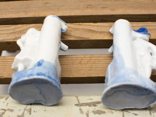 Handcrafted ceramic figures with blue detailing, inspired by traditional Dutch folk art.