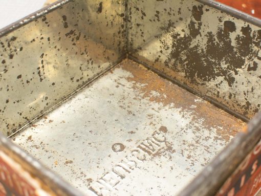 Vintage metal tin box for Meursing biscuits, showcasing wear and nostalgic charm.