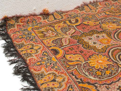Colorful handwoven shawl with intricate floral and geometric designs, perfect for decor and style.