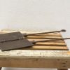 Vintage cast iron waffle irons on rustic wood, perfect for traditional waffle making.
