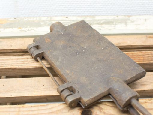 Antique metal tool with hinge mechanism, showcasing vintage craftsmanship and rustic charm.