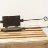 Antique iron waffle maker with rustic patina, perfect for nostalgic cooking experiences.