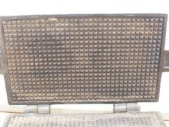 Antique cast iron waffle iron, a charming vintage kitchen accessory with a rich history.
