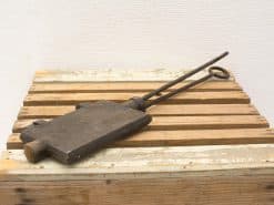 Rustic vintage tool with a wooden handle and metal shaft, showcasing timeless craftsmanship.