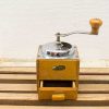 Vintage wooden coffee grinder with metal mechanism, showcasing timeless charm and practicality.