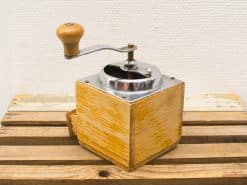 Vintage wooden coffee grinder with metal accents, perfect for grinding beans and home decor.