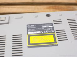 Vintage Sony PlayStation SCPH-5502 console underside, showcasing its iconic gray design and technical labels.
