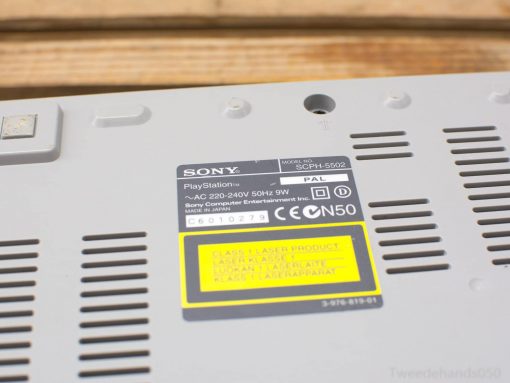 Vintage Sony PlayStation SCPH-5502 console underside, showcasing its iconic gray design and technical labels.
