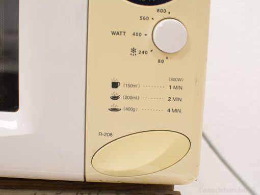 Vintage Sharp R-208 microwave with user-friendly control panel and adjustable wattage settings.
