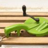 Vintage green corn stripper for efficient kernel removal in traditional kitchens.
