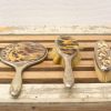 Vintage tortoiseshell grooming set: mirror, hairbrush, and small brush for elegant vanity decor.