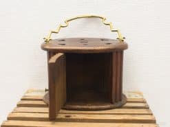 Charming vintage wooden container with brass handle, perfect for storage and rustic decor.