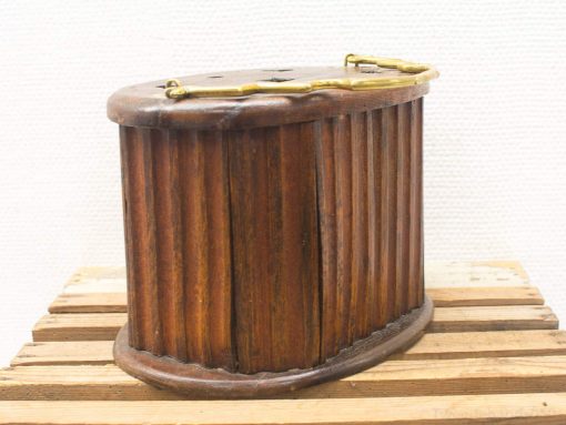 Vintage wooden storage container with brass handle, showcasing rustic charm and craftsmanship.