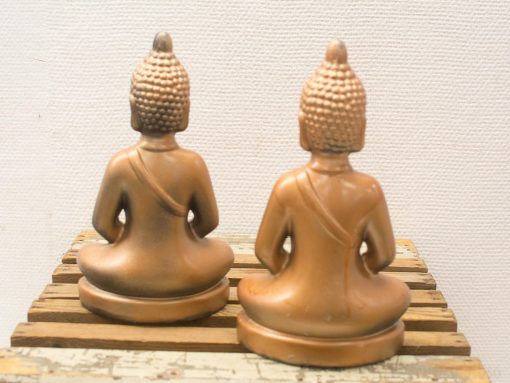 Serene Buddha statues on rustic wooden base, perfect for creating a peaceful ambiance.